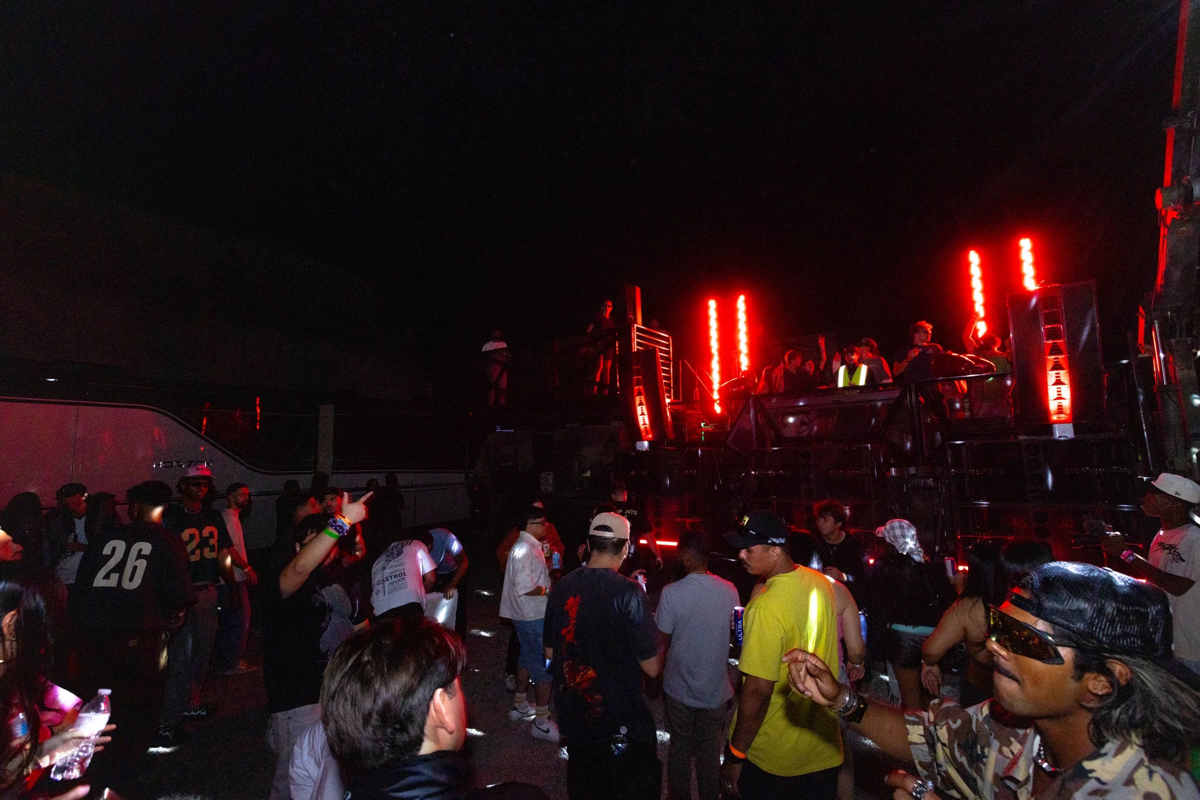 Red stage lights over a packed live show at BRICKS