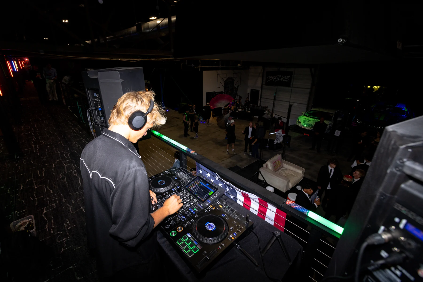 A DJ working the decks above the BRICKS warehouse floor